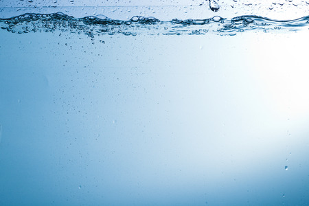 Flowing water, drops, sprays, splashes on a neutral background, studio light, abstraction, minimalismの写真素材