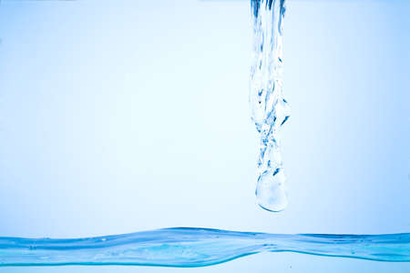 Flowing water, drops, sprays, splashes on a neutral backgroundの写真素材