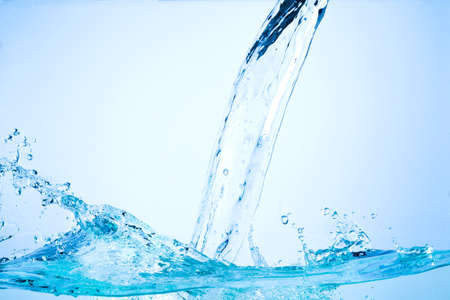 Flowing water, drops, sprays, splashes on a neutral background