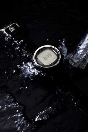 Watches for scuba diving in streams of water on a black background, studio lightの写真素材