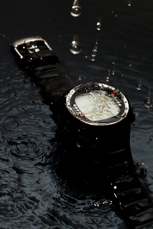 Watches for scuba diving in streams of water on a black background, studio lightの写真素材
