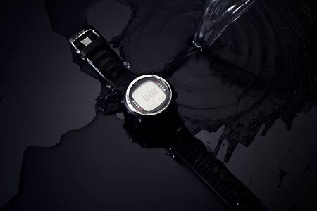 Watches for scuba diving in streams of water on a black background, studio lightの写真素材
