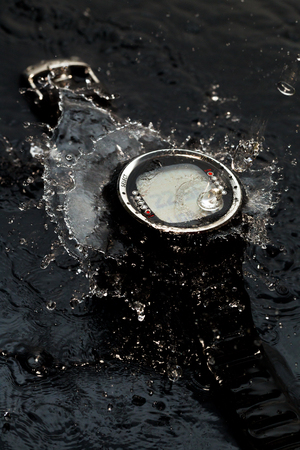 Watches for scuba diving in streams of water on a black background, studio lightの写真素材