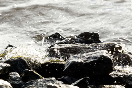 Stones on water background, wave, natural light, Macroの写真素材