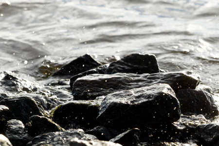 Stones on water background, wave, natural light, Macroの写真素材
