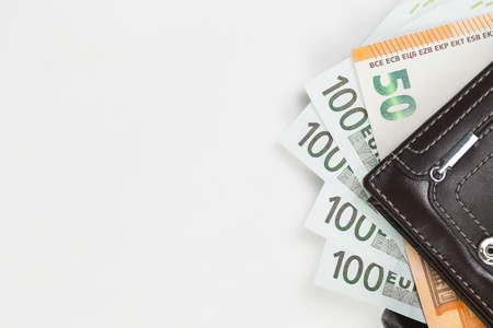 Finance. Money. Euro. Rubles. Dollar bills and wallet on a white background. Top view. Studio light