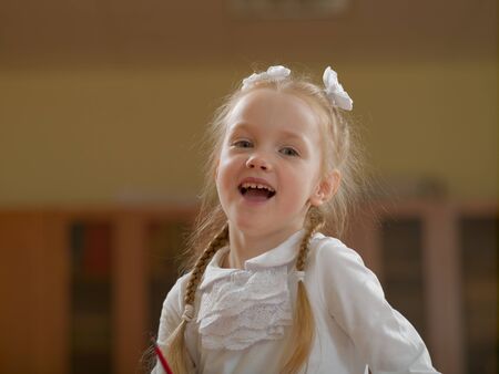Emotional schoolgirl in the classroom at the lesson