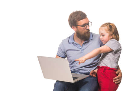 Little redhead girl with dad behind a laptop on a white isolated background
