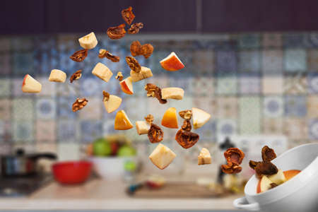 dried fruits, apples, bananas and nuts to throw the air. falling fruitfruit. Healthy food for Breakfast, side viewの写真素材