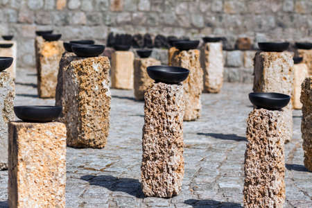 Rainwater harvesting. Installation a plate on a stone collects rainwater