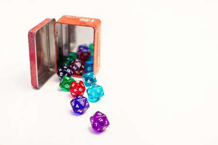 A lot Dices for board games in orange box, isolate on whiteの写真素材