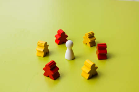 Teamwork concept - board game meeples surrounded figureの写真素材
