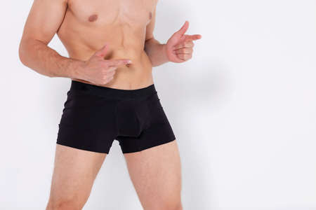 Muscular young man wearing underwear isolated on white background. Black underwear for men.の写真素材