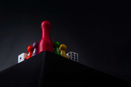 Time to play a game - board game concept. Many figures,, dice and sandglass. Dark background free...