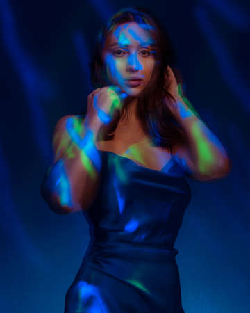 Portrait in the style of light painting. Brunette woman in blu dress long exposure photo, abstract portrait light and freezelight backgroundの写真素材