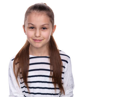 Portrait of a happy smiling child girl. Cute 8 years old girl Isolated over white backgroundの写真素材