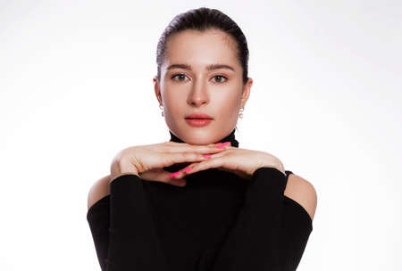 Woman with short hair and clean skin. Face close up, skin beauty tanned, beautiful smile woman in black turtleneck over white backgroundの写真素材