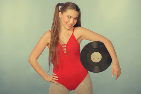 Young girl with vinyl disc in retro styleの写真素材