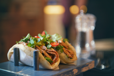 Two fresh delicious Tacos on a blue trayの写真素材