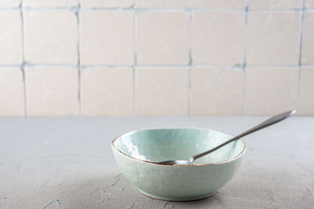 Blue bowl on kitchen background with ceramic tilesの写真素材
