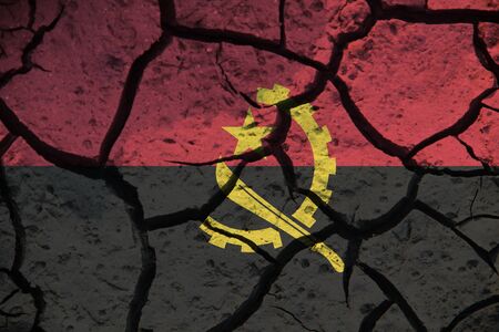 Angola flag on the background texture of cracked earth. The concept of design solutions.の写真素材