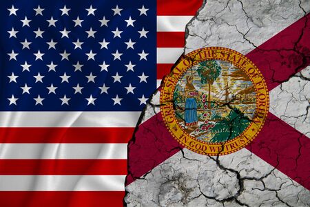 United States flag weaving texture with  flag of Florida on cracked ground, concept of state drought.の写真素材