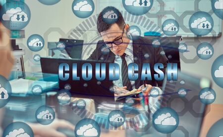 Cloud storage icons flying from the center. Hands of a businessman using a laptop with a smartphone...