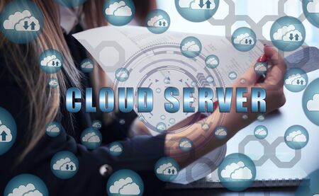 Cloud storage icons flying from the center. A group of young people sitting at a table discussing...