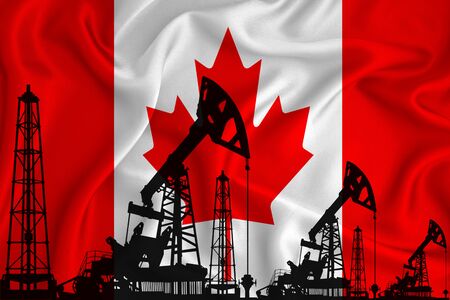 Silhouette of drilling rigs and oil derricks on the background of the flag of canada. Oil and gas industry. The concept of oil fields and oil companies.の写真素材