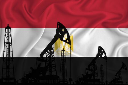 Silhouette of drilling rigs and oil derricks on the background of the flag of Egypti. Oil and gas industry. The concept of oil fields and oil companies.の写真素材