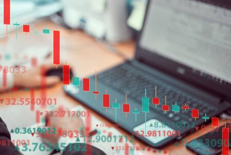 Young businessmen are analyzing the stock market at laptop. Business and finance, technology,...