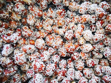 Round chocolates sprinkled with sesame seeds on the surface. View from above.の写真素材