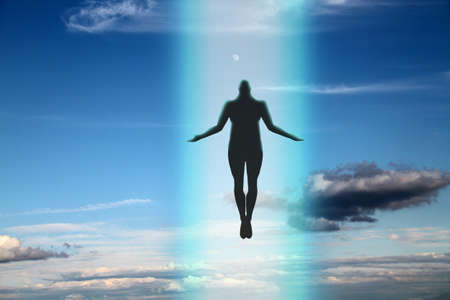 The dark silhouette of the soul of a deceased person ascends to heaven against a background of...