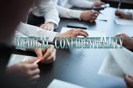 A group of doctors in a modern clinic is planned. The concept of modern medicine and medical biotenology. Medical icons on the screen with the inscription: MEDICAL CONFIDENTIALITYの写真素材