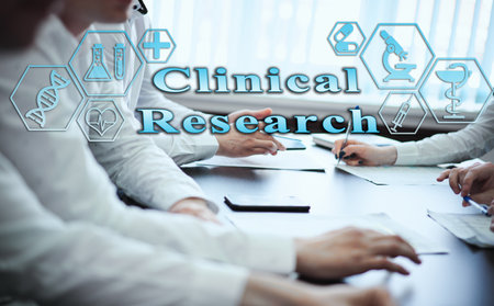 Medical healthcare concept - group of doctors in hospital with digital medical icons, graphic banner showing symbol of medicine, providing medical care. The inscription "Clinical Research"の写真素材