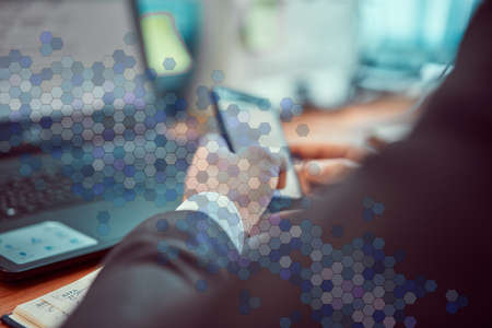 Business man in modern office engaged working on a laptop.