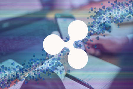 Ripple, xrp cryptocurrency sign. Business person, trader, investor, analyst using mobile phone app analytics to analyze cryptocurrency financial stock market analyze chart on smartphone screen.の写真素材