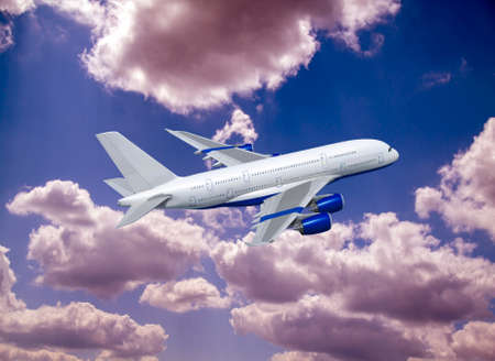 Commercial white plane airliner flying over dramatic clouds. Travel concept.の写真素材