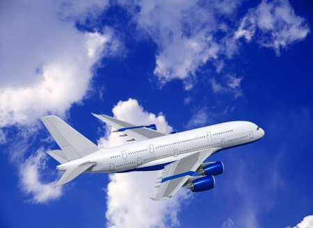 Commercial white plane airliner flying over dramatic clouds. Travel concept.の写真素材