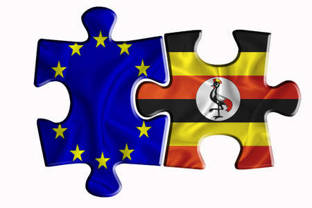 Uganda flag and European Union flag on two puzzle pieces on white isolated background. The concept of political relations. 3D renderingの写真素材