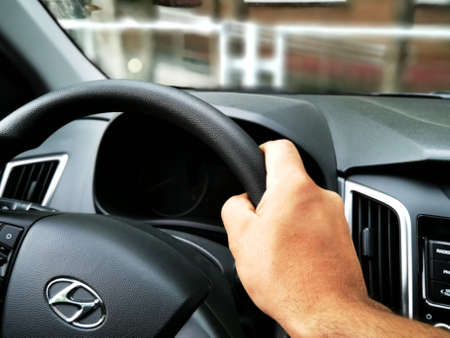 Moscow, Russia - February 29, 2021: The car overturned after an accident. The driver stands near the wrecked car. Road traffic accidentのeditorial素材
