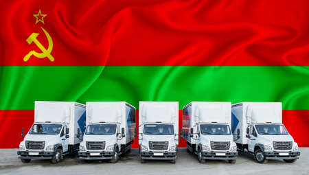Transnistria flag in the background. Five new white trucks are parked in the parking lot. Truck, transport, freight transport. Freight and logistics conceptの写真素材