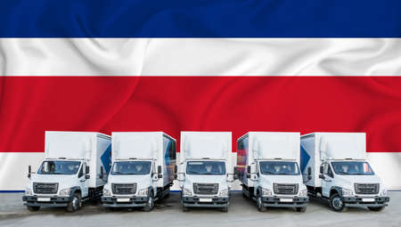 Thailand flag in the background. Five new white trucks are parked in the parking lot. Truck, transport, freight transport. Freight and logistics conceptの写真素材