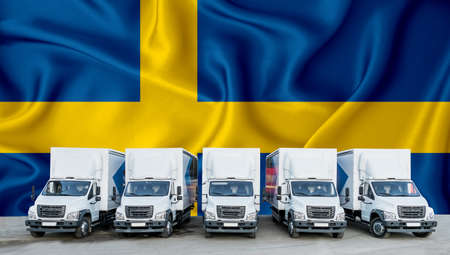 Sweden flag in the background. Five new white trucks are parked in the parking lot. Truck, transport, freight transport. Freight and logistics conceptの写真素材