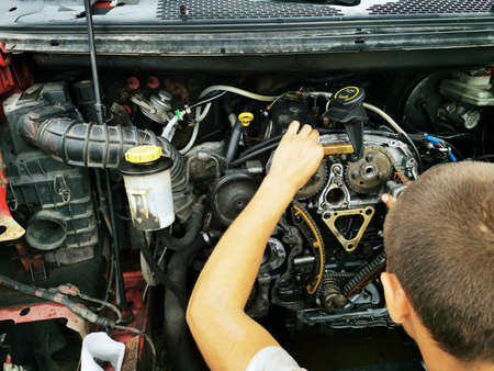 Repair of the internal combustion engine of a passenger car. repair of an open motor gear replacement.の写真素材
