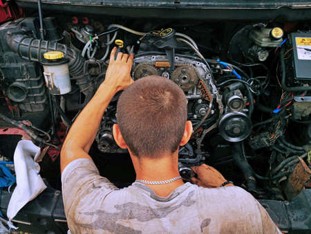 Repair of the internal combustion engine of a passenger car. repair of an open motor gear replacement.の写真素材