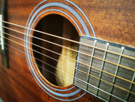 Hands of a man playing the guitar. Bending technique. Low key photo.の写真素材