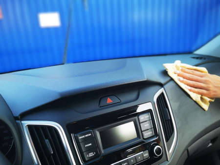 A young girl at a car wash, washes the car using a microfiber cloth. Selective focus.の写真素材