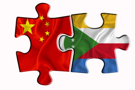 comores flag and China of America flag on two puzzle pieces on white isolated background. The concept of political relations. 3D renderingの写真素材
