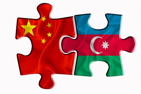 Azerbaijan flag and China of America flag on two puzzle pieces on white isolated background. The concept of political relations. 3D renderingの写真素材